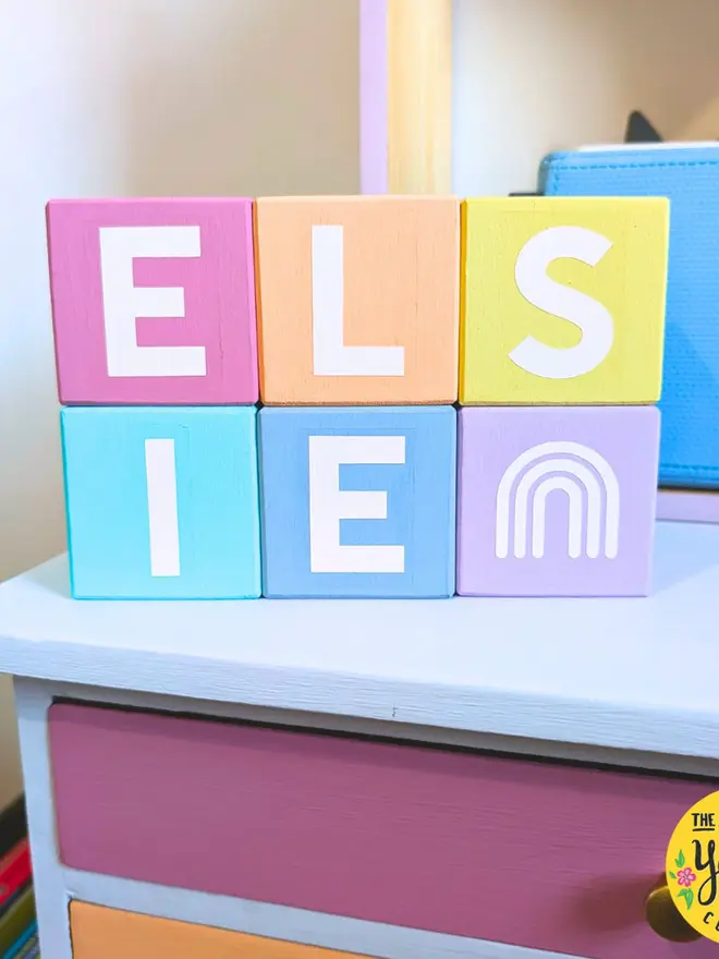 personalised hand-painted name blocks. the name 'elsie' spelt in different coloured square blocks.
