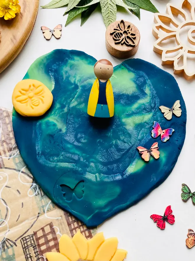 earth sensory play dough. a craft set up with earth blue and green play dough.