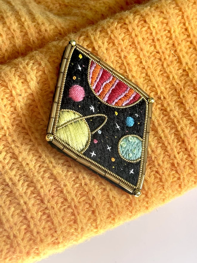 Planets brooch on hat