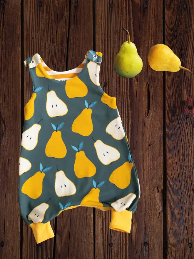 Pears on green teal romper organic cototn jersey on a wooden table with pears