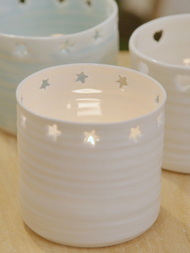 Star holed porcelain tea light holders in a cluster of three