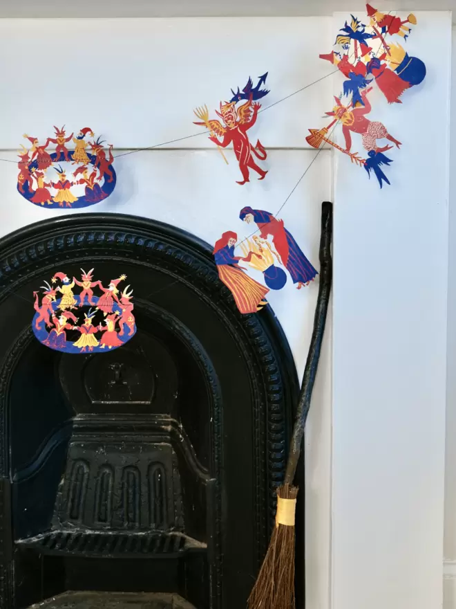 Witches and wizard shapes draped across white fireplace