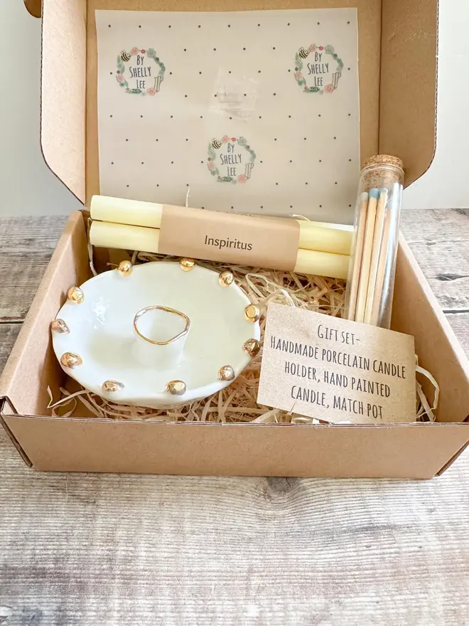 Handmade Gold Star Porcelain Candle Holder Gift (Set Of 3), gift set packaged on a cardboard box on a table. 