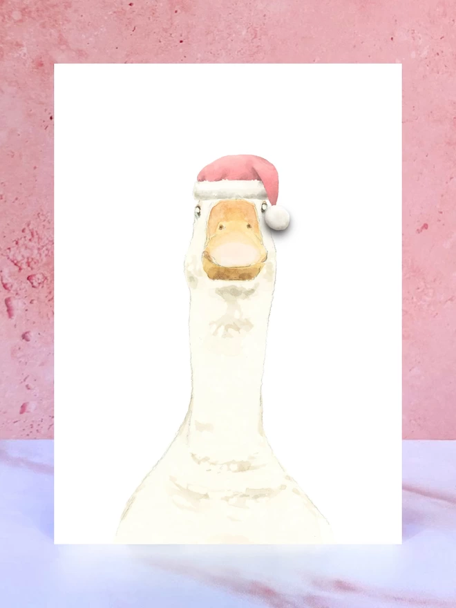 A Christmas card featuring a hand painted design of a goose, stood upright on a marble surface. 