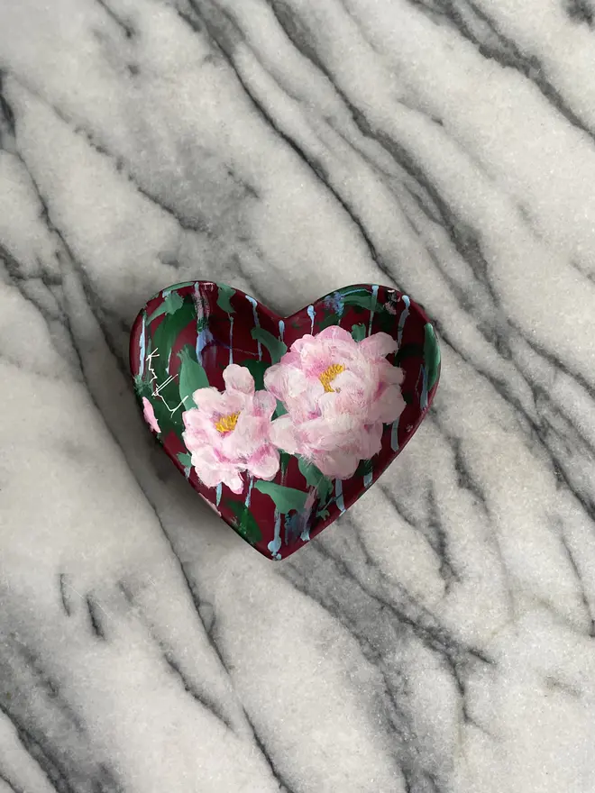 hand painted floral ceramic heart shaped keepsake dish background in a deep red and blue stripe with pink peony flowers