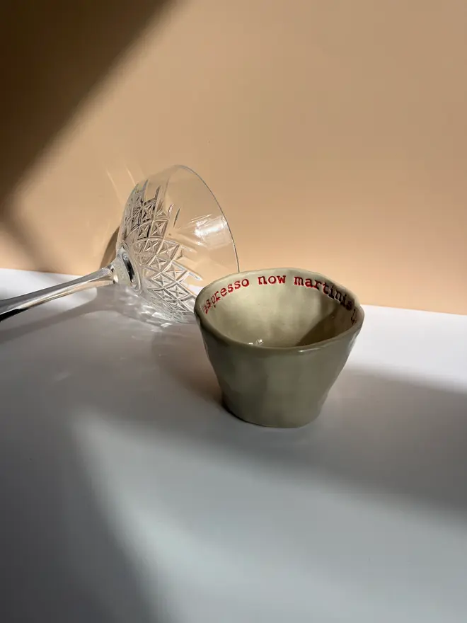 'Espresso Now Martini Later' Espresso Cup, on table with martini glass. 