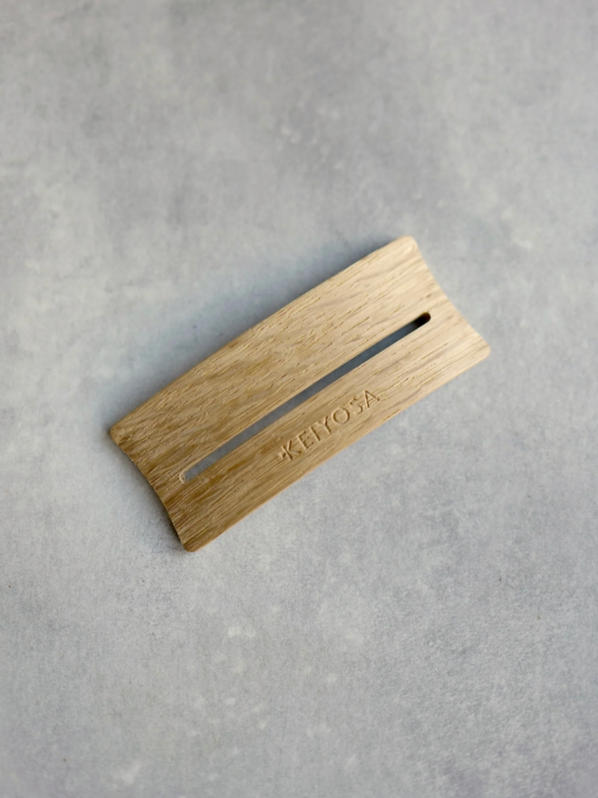 Arch Place Card Holder. The place card holder is shown here alone. It is a pleasing tan colour and made of wood.