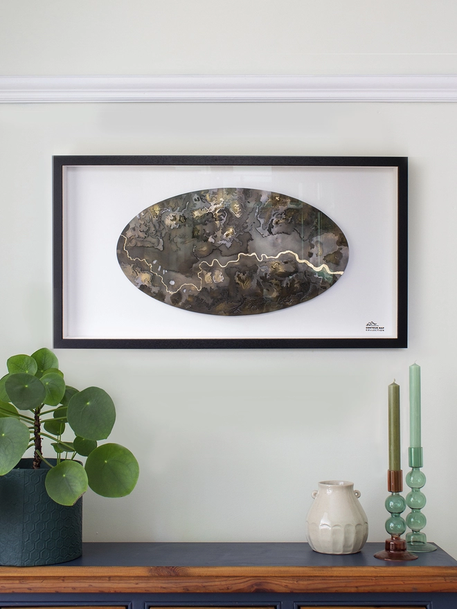 Brass London Contour Map Wall Piece, in a black frame on the wall