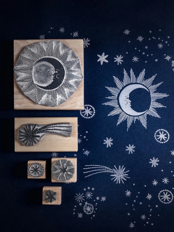 sun, moon, stars rubber stamps on a dark blue background
