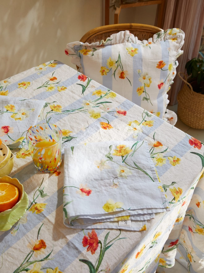 Table laid with linens printed with daffodils