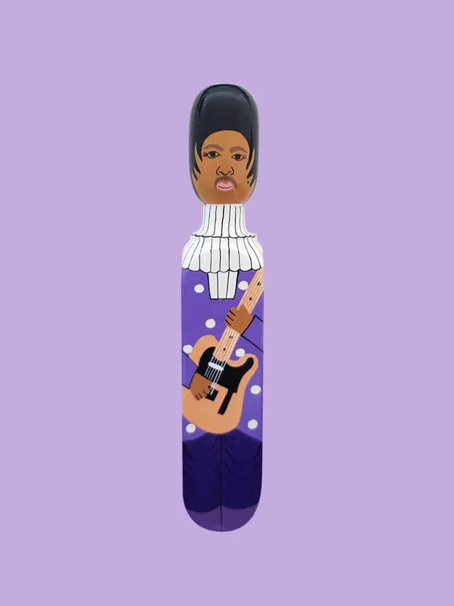 Wooden Door Stopper (The Purple One), a colourful wooden door stop sitting on a white surface. 