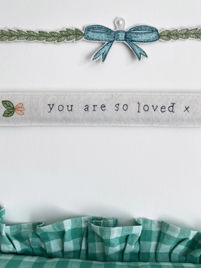 You are so loved embroidered felt sign on wall with bow decoration