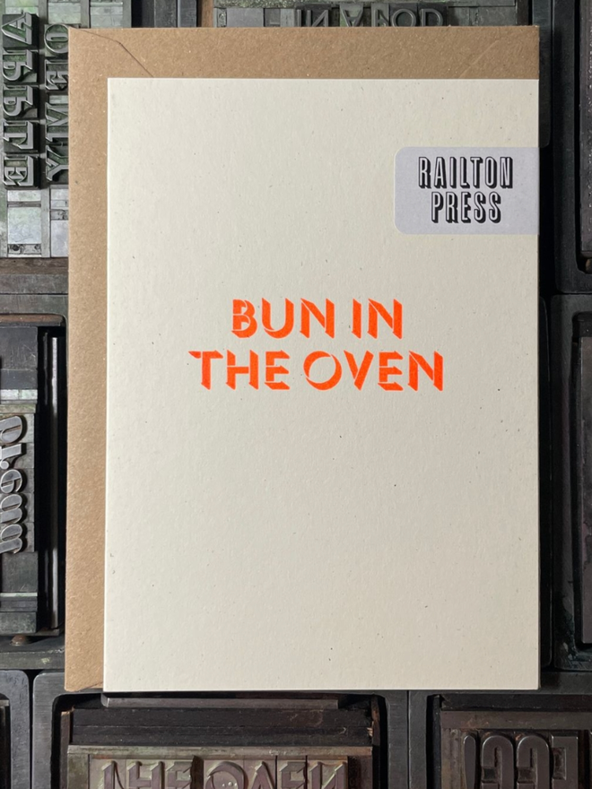 Bun in the Oven Card. A card with simple orange lettering.