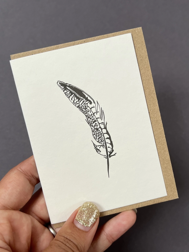 A small card with the Pheasant feather design on the front, all elements are 100% recycled and recyclable 