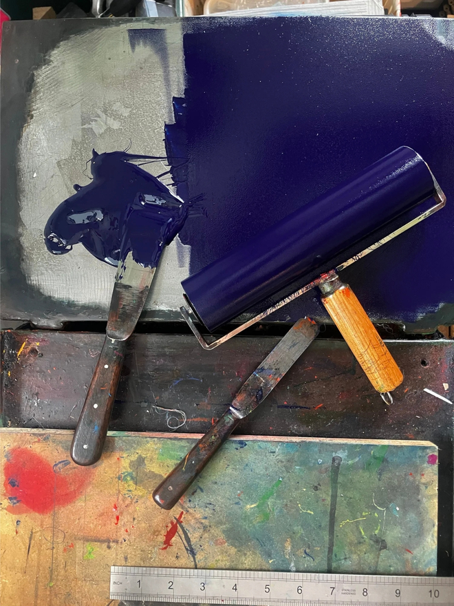 capricorn zodiac linocut. a linocut goat and zodiac symbols printed on a blue background.