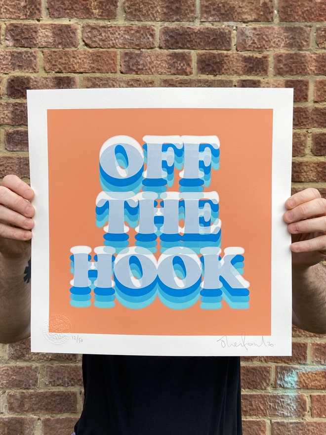 "Off The Hook" Hand Pulled Screen Print square with orange coral background and the words off the hook printed on top in shades of blue 