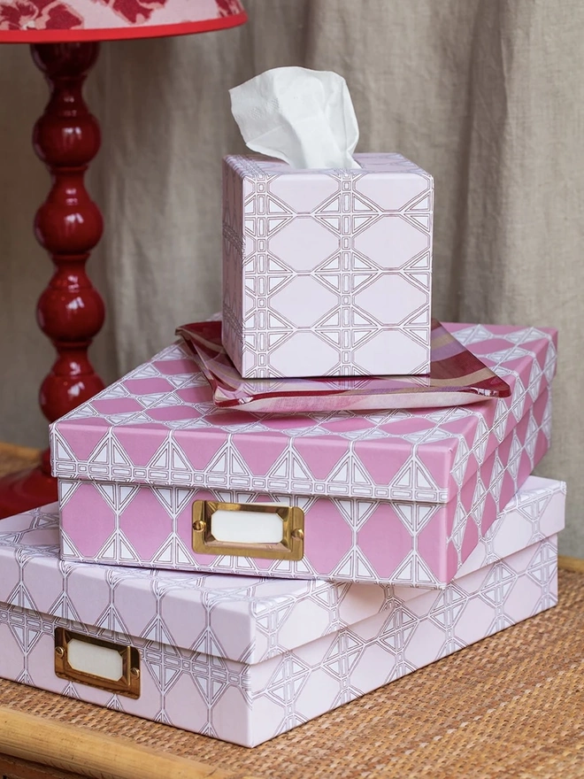 Tijan Tissue Box Cover, a colourful tissue box sitting on a desk. It is accompanied by other desk accessories. 