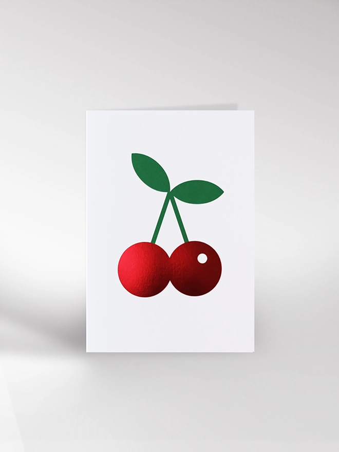 Greeting card with red metallic cherries