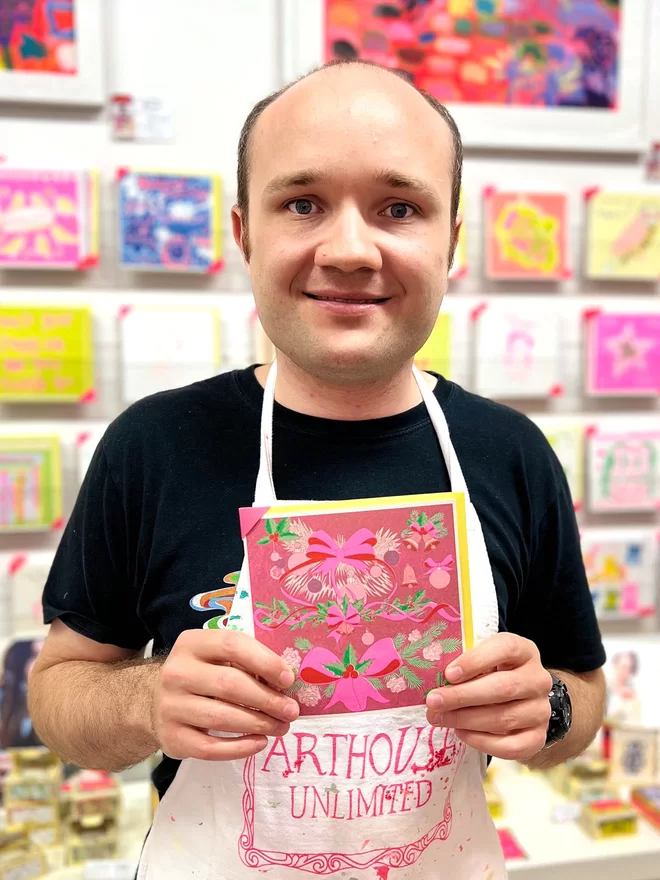 Artist holding a handmade riso printed card, Christmas Greeting Card, Holiday Card, Christmas Bows