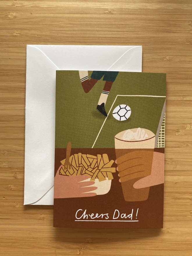 Greetings card, with image of two hands holding a pint of beer and chips at a football match. The text says Cheers Dad!