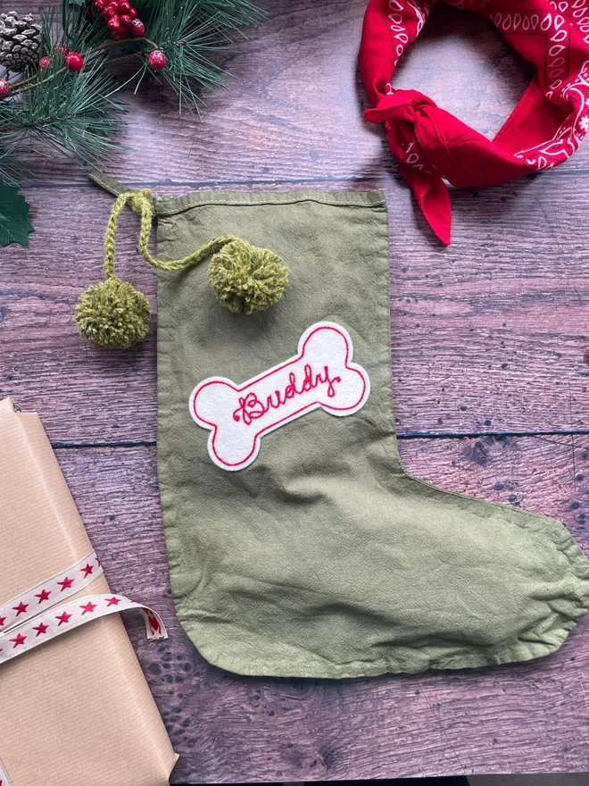 Personalised Dog Christmas stocking in olive green with a cream and red bone patch