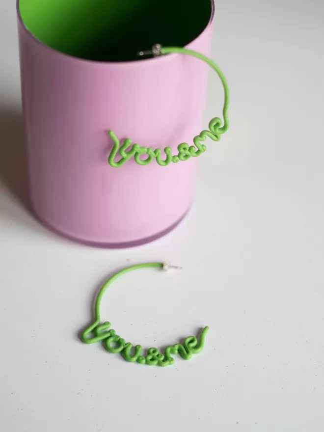 You & Me hoops by Zoe Sherwood large in green seen in a pink cup.