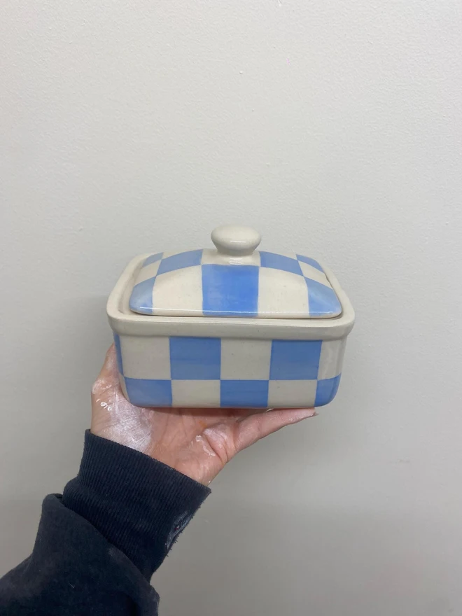  Checkered Blue & Cream Handmade Ceramic Butter Dish, a blue patterned butter dish held against a white backdrop. 