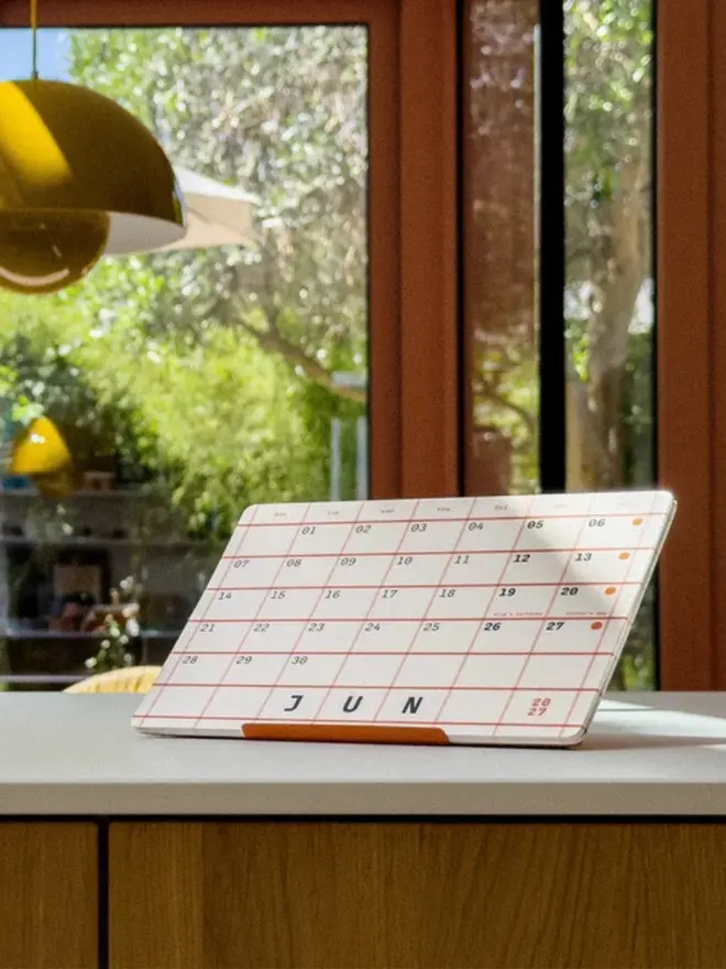 Squared: 2027 Monthly Desk Calendar, on a table. 