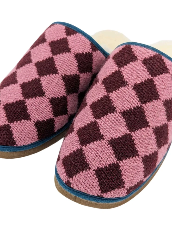 Lambswool & Sheepskin Slippers, a pair of colourful lambswool and sheepskin slippers sitting on a plain white surface. 