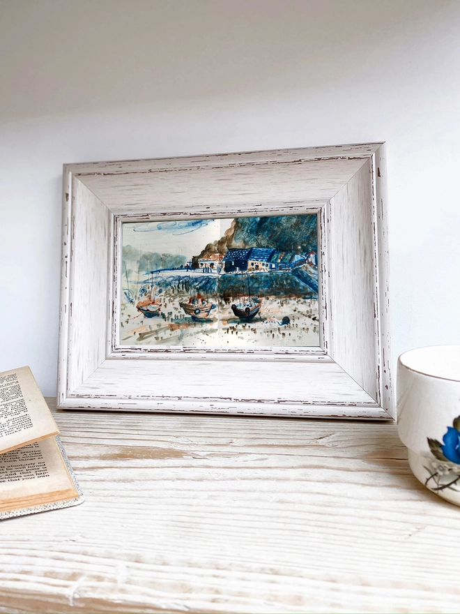 a sea scape painting with boats, framed