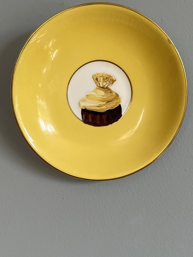 yellow saucer with chocolate painting
