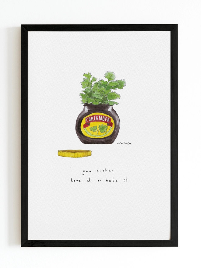 Watercolour painting of a Marmite jar with coriander coming out of the top and the lid laying next to the jar. The branding on the jar reads coriander (instead of marmite) with the same marmite writing style. Thin black hand lettering below reads ‘coriander, you either love it or hate it’. The print is mounted on white card and framed with a black frame. 