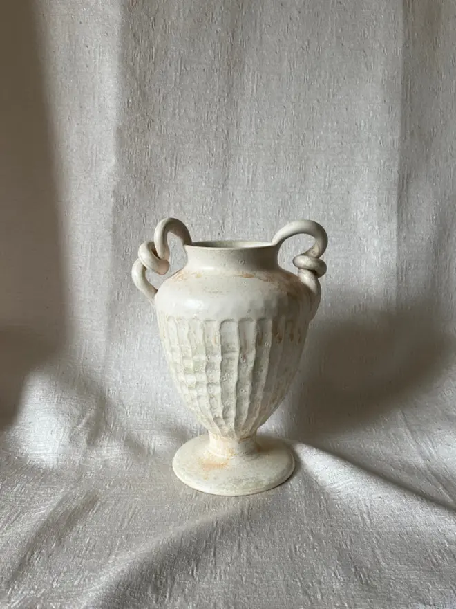 Urn Vase on white cloth background