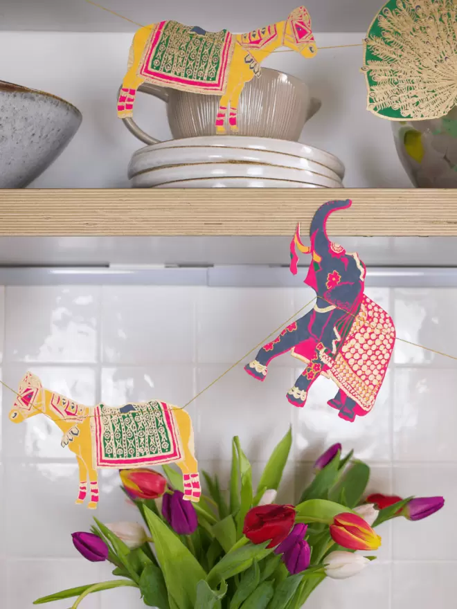 Gold embellished elephant and donkeys with purple and red tulips