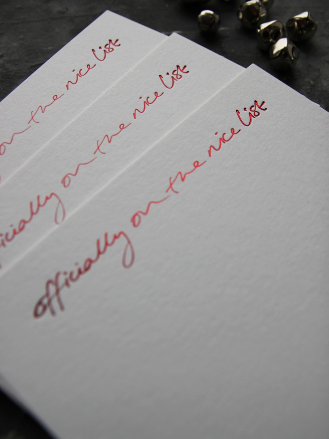 christmas notecard form Santa that says Officially On The Nice List in red foil with an envelope that says North Pole Mail