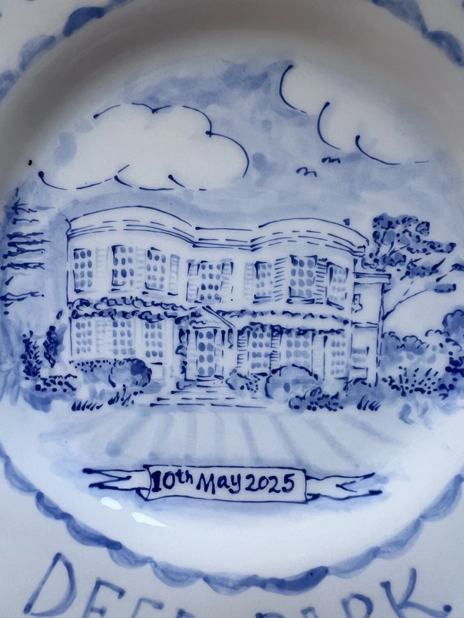 Close up of central image of "deer park" painted in blue and white on a ceramic pottery plate