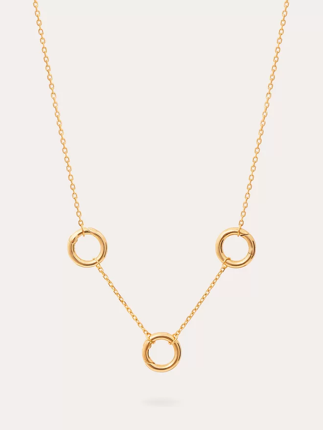 still life image of a triple link gold fine link chain necklace