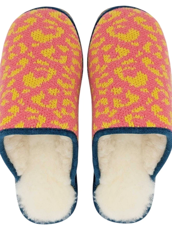 Lambswool & Sheepskin Slippers, a pair of colourful lambswool and sheepskin slippers sitting on a plain white surface. 
