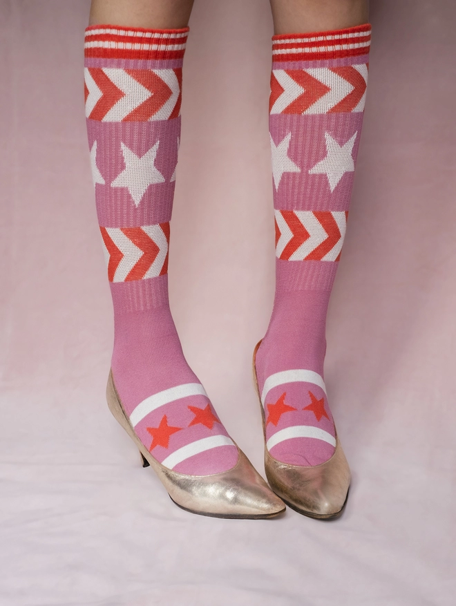 Pink sprorty socks with gold shoes