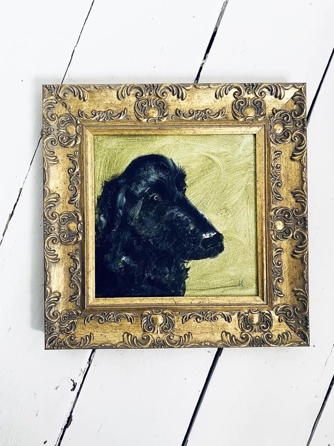 framed portrait of pet dog with black shiny nose and gold frame