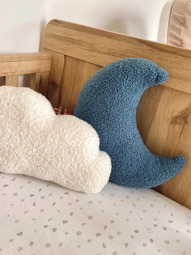 boucle moon and cloud pillow set. a blue moon and white cloud cushion on a sofa.