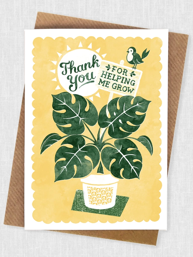 yellow and green teacher thank you card with brown envelope showing green pot plant and bird