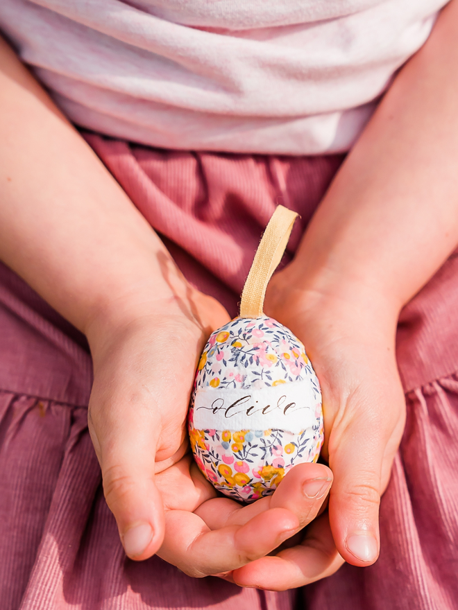 Personalised liberty fabric decorative egg in child's hands