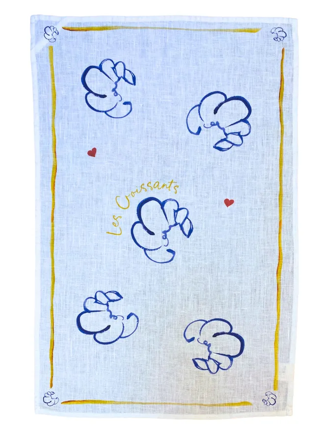 Linen teatowel with whimsical hand painted illustration of croissants