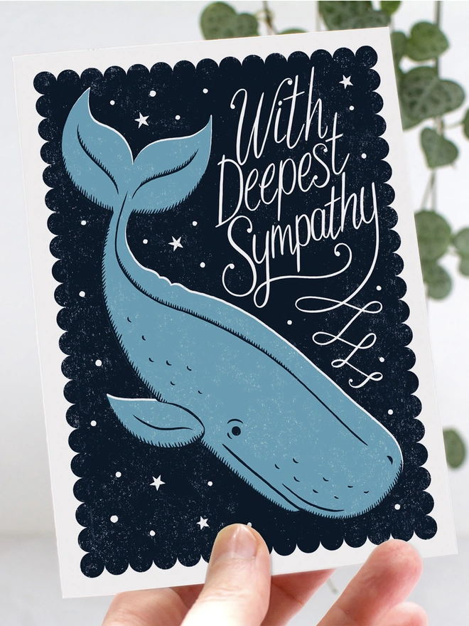 hand holding blue whale sympathy card