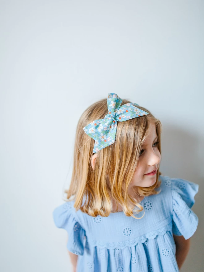 Littel girl wearing her liberty blossom alice band