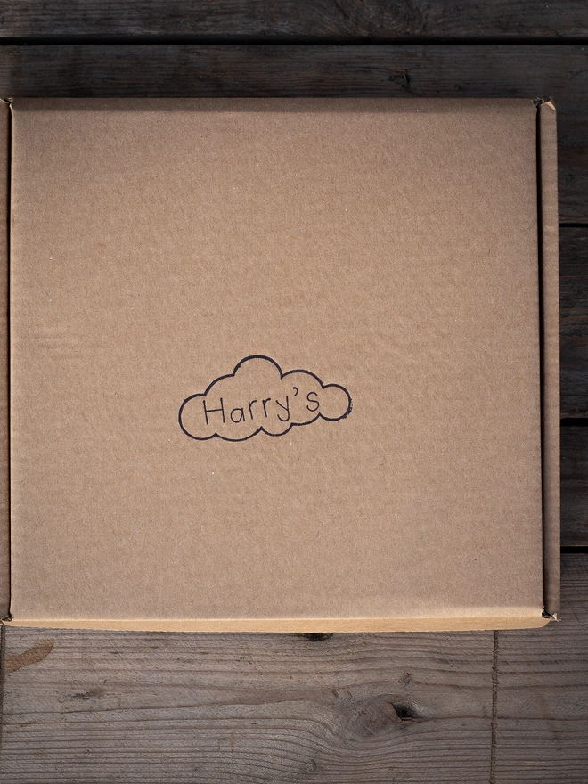Rustic brown packaging stamped with the Harry's logo.