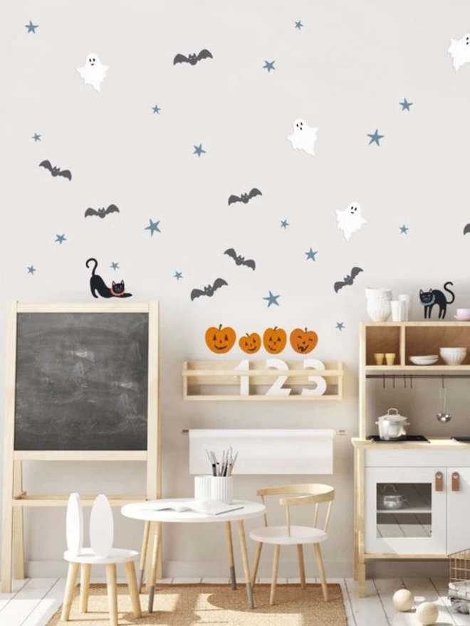 Halloween stickers in playroom with chalk board and toy kitchen