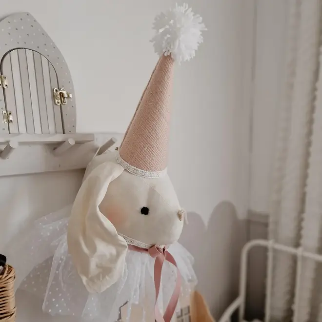 Rabbit Head Wall Mount, a cotton rabbit head wall decoration in a child's bedroom accompanied by other bedroom accessories. 