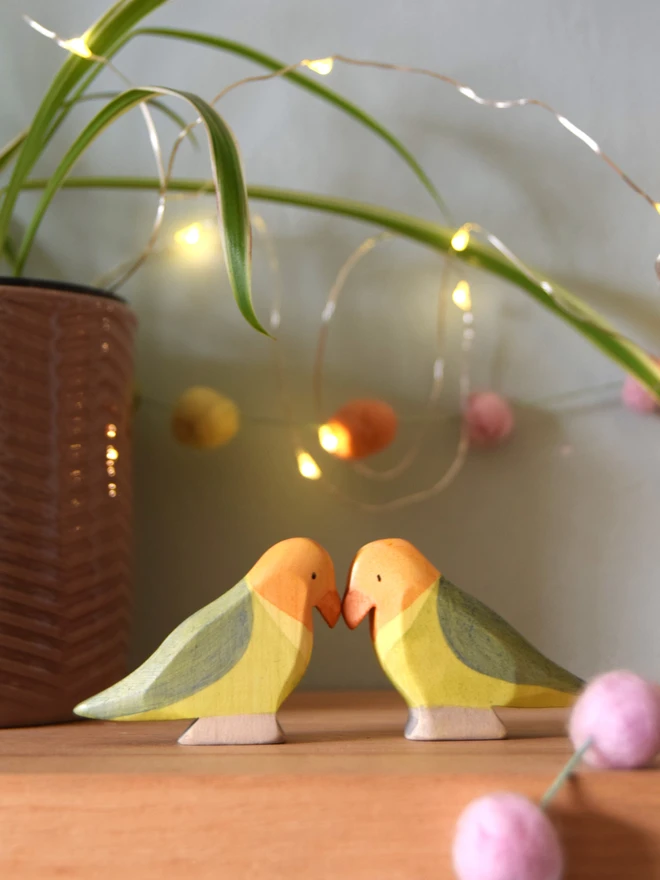 wooden toy lovebirds on toy shelf